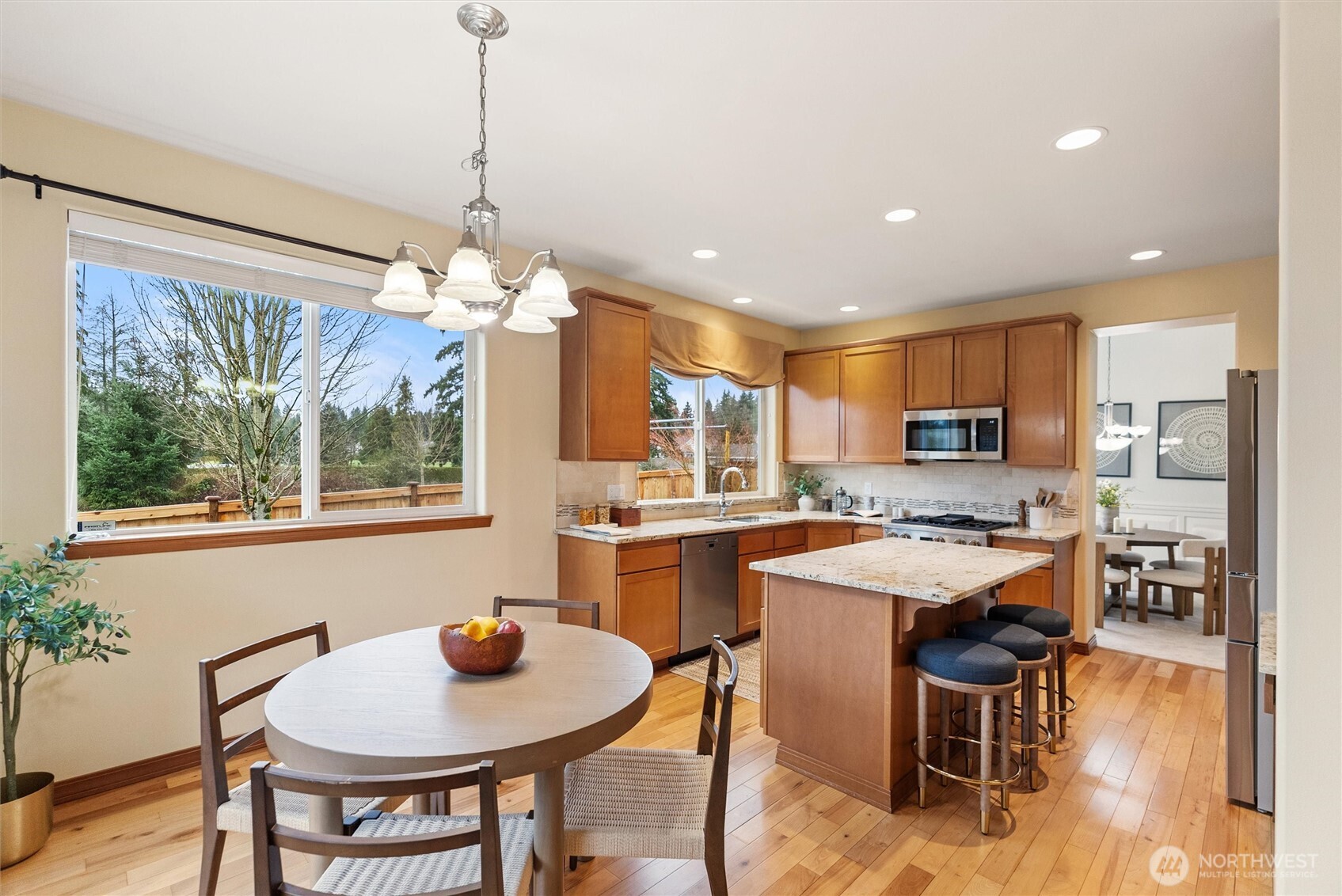 18722 3rd Avenue West Bothell, WA 98012 - Photo 10 of 35 a kitchen with a dining table chairs stainless steel appliances and cabinets