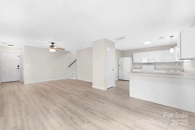 a view of a kitchen with a sink and a refrigerator