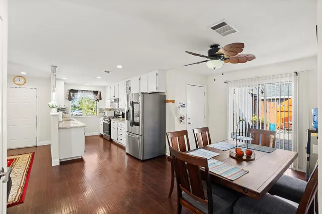 a kitchen with white cabinets and appliances