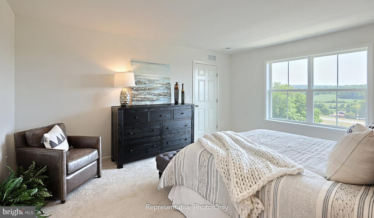 109 Copper Ridge Drive Newmanstown, PA 17073 - Photo 21 of 27 a bedroom with a bed and wooden floor
