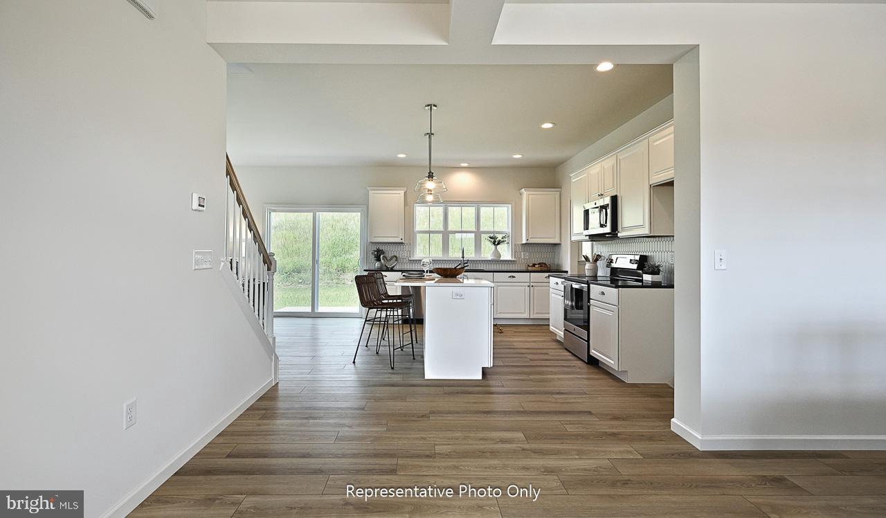 109 Copper Ridge Drive Newmanstown, PA 17073 - Photo 4 of 27 a large kitchen with white cabinets and stainless steel appliances