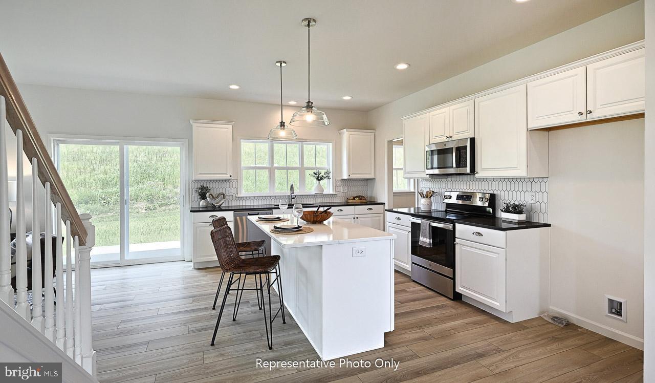 109 Copper Ridge Drive Newmanstown, PA 17073 - Photo 8 of 27 a kitchen with a sink a counter top space appliances and a window