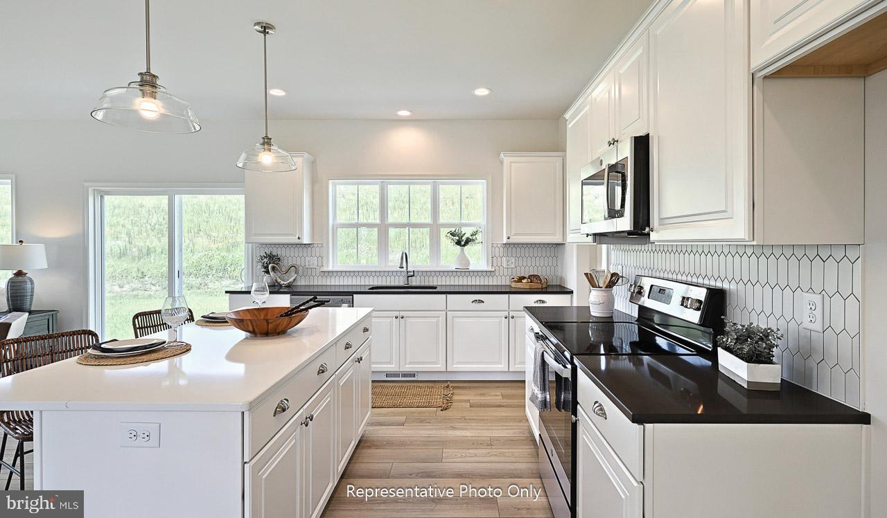 109 Copper Ridge Drive Newmanstown, PA 17073 - Photo 10 of 27 a kitchen with a sink stove top oven and cabinets