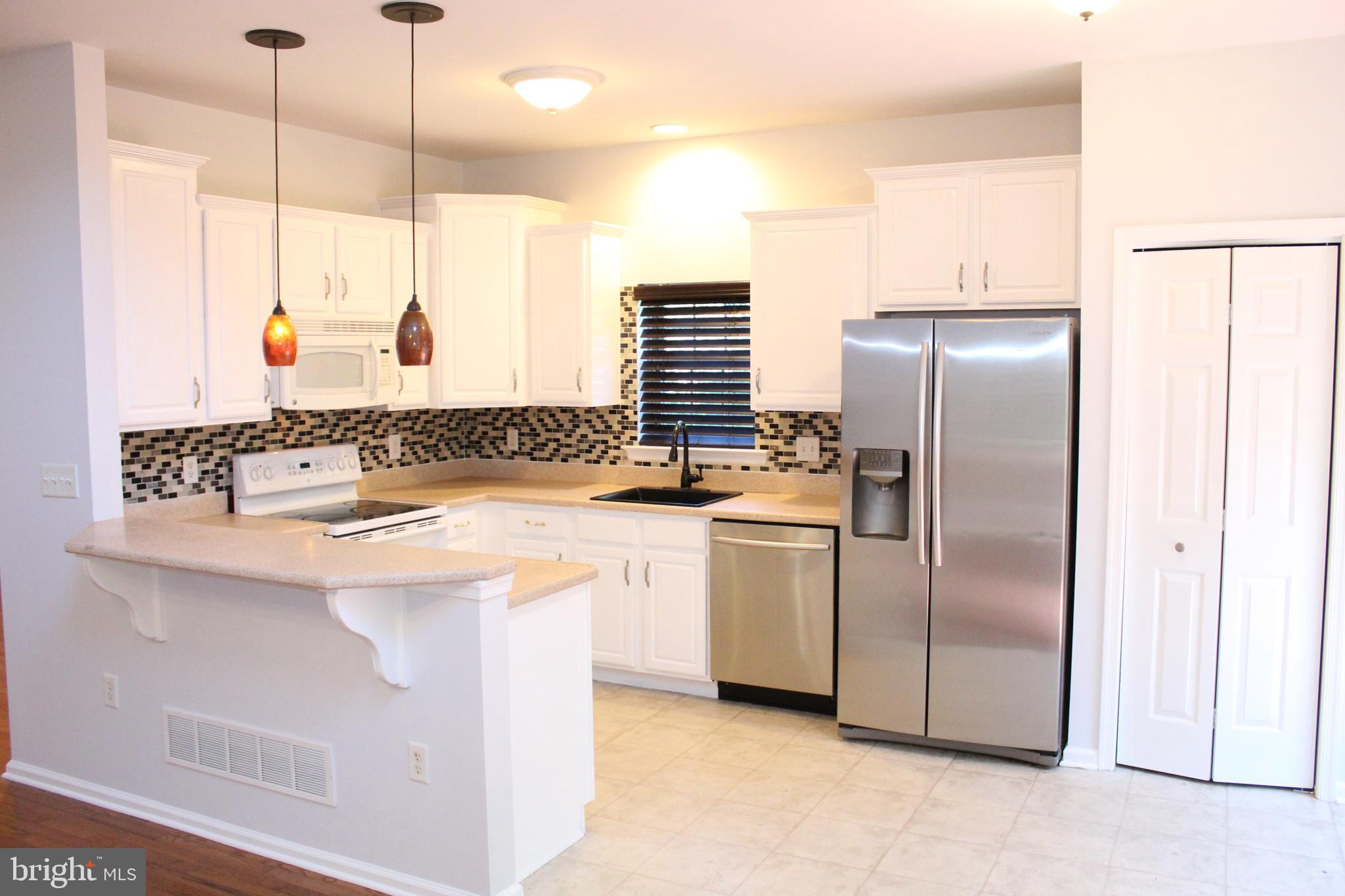 15 Ryan Court Telford, PA 18969 - Photo 13 of 26 a kitchen with stainless steel appliances granite countertop a refrigerator a sink and a stove