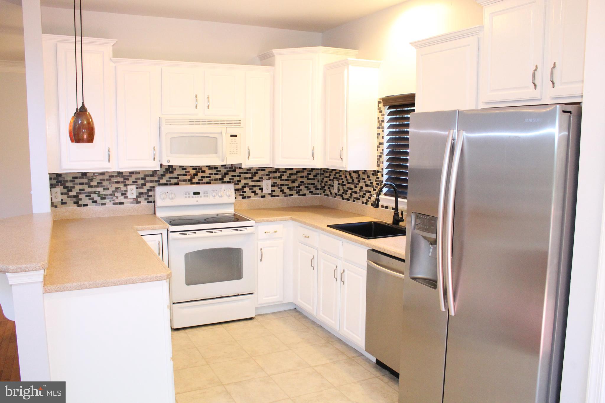 15 Ryan Court Telford, PA 18969 - Photo 14 of 26 a kitchen with a stove a sink and a refrigerator
