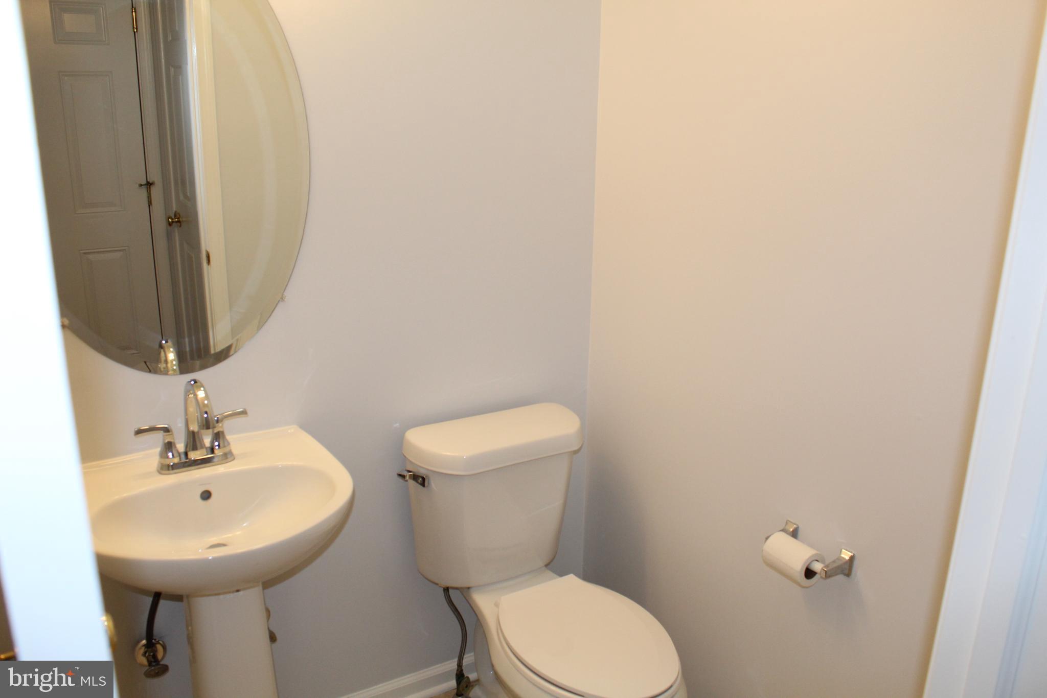 15 Ryan Court Telford, PA 18969 - Photo 17 of 26 a bathroom with a toilet sink and mirror