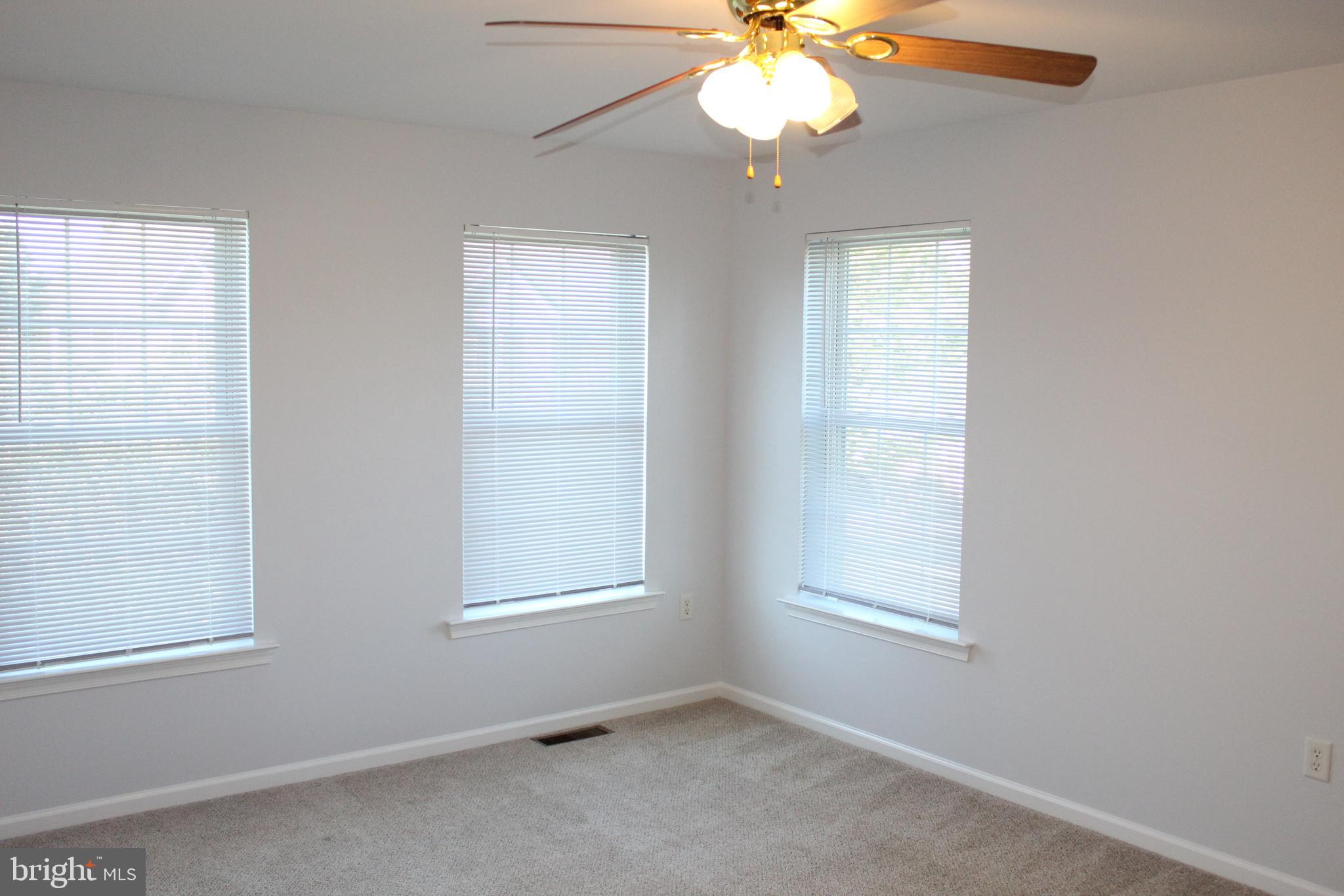 15 Ryan Court Telford, PA 18969 - Photo 20 of 26 an empty room with windows and chandelier fan