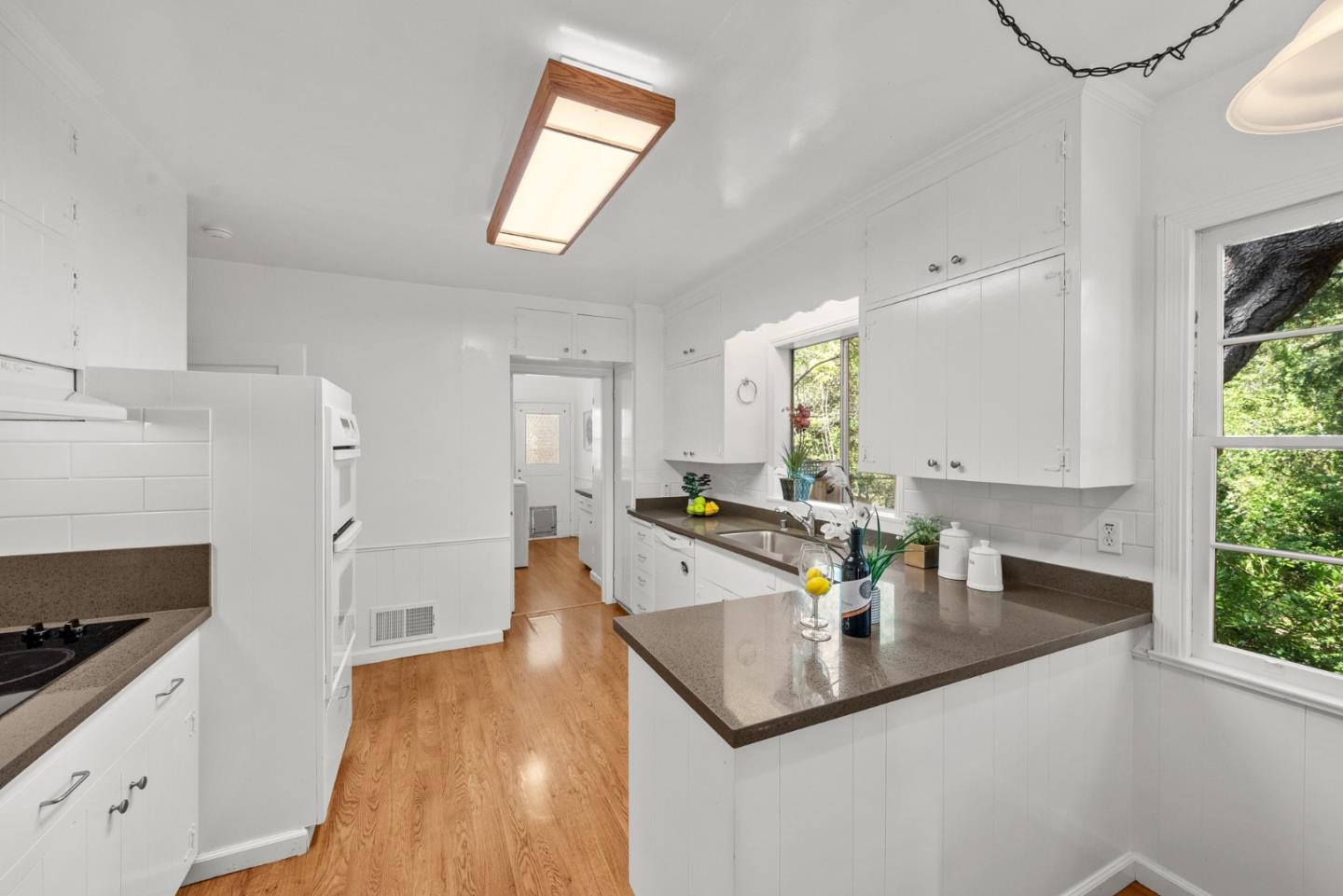 410 Fulton Road San Mateo, CA 94402 - Photo 19 of 49 a kitchen with stainless steel appliances granite countertop a sink a stove and a wooden floor