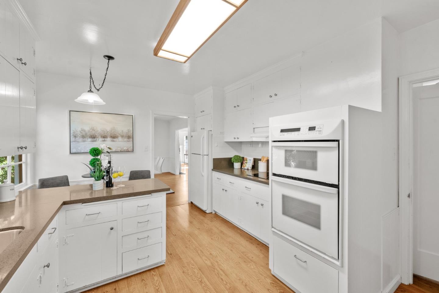 410 Fulton Road San Mateo, CA 94402 - Photo 23 of 49 a kitchen with white cabinets and white appliances