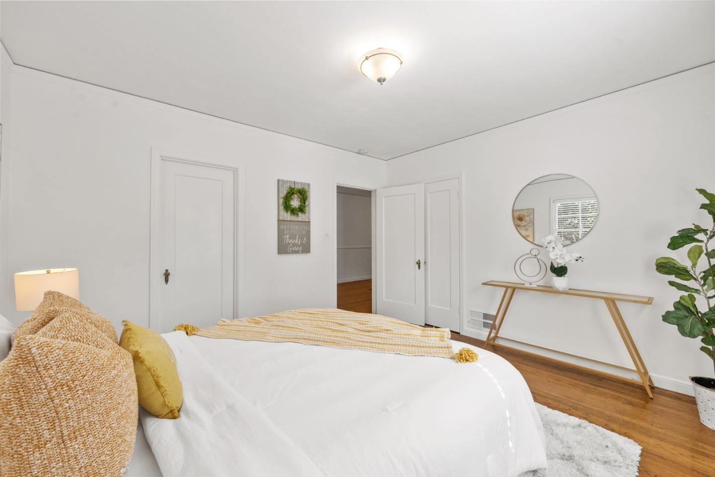 410 Fulton Road San Mateo, CA 94402 - Photo 25 of 49 a bedroom with a bed and a chandelier