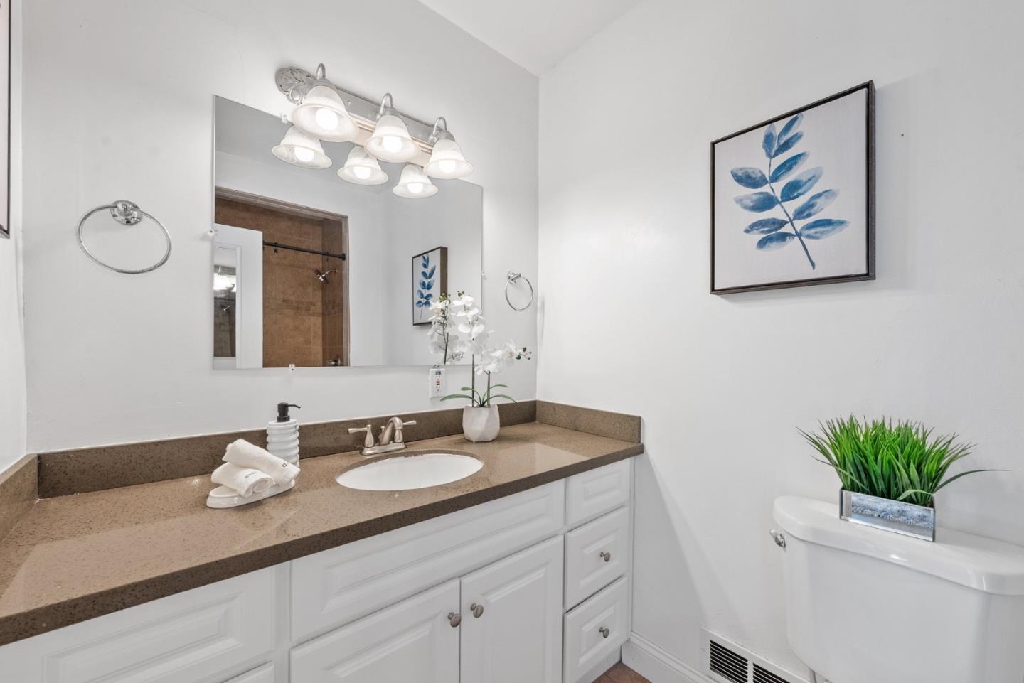 410 Fulton Road San Mateo, CA 94402 - Photo 30 of 49 a bathroom with a granite countertop sink a mirror and vanity