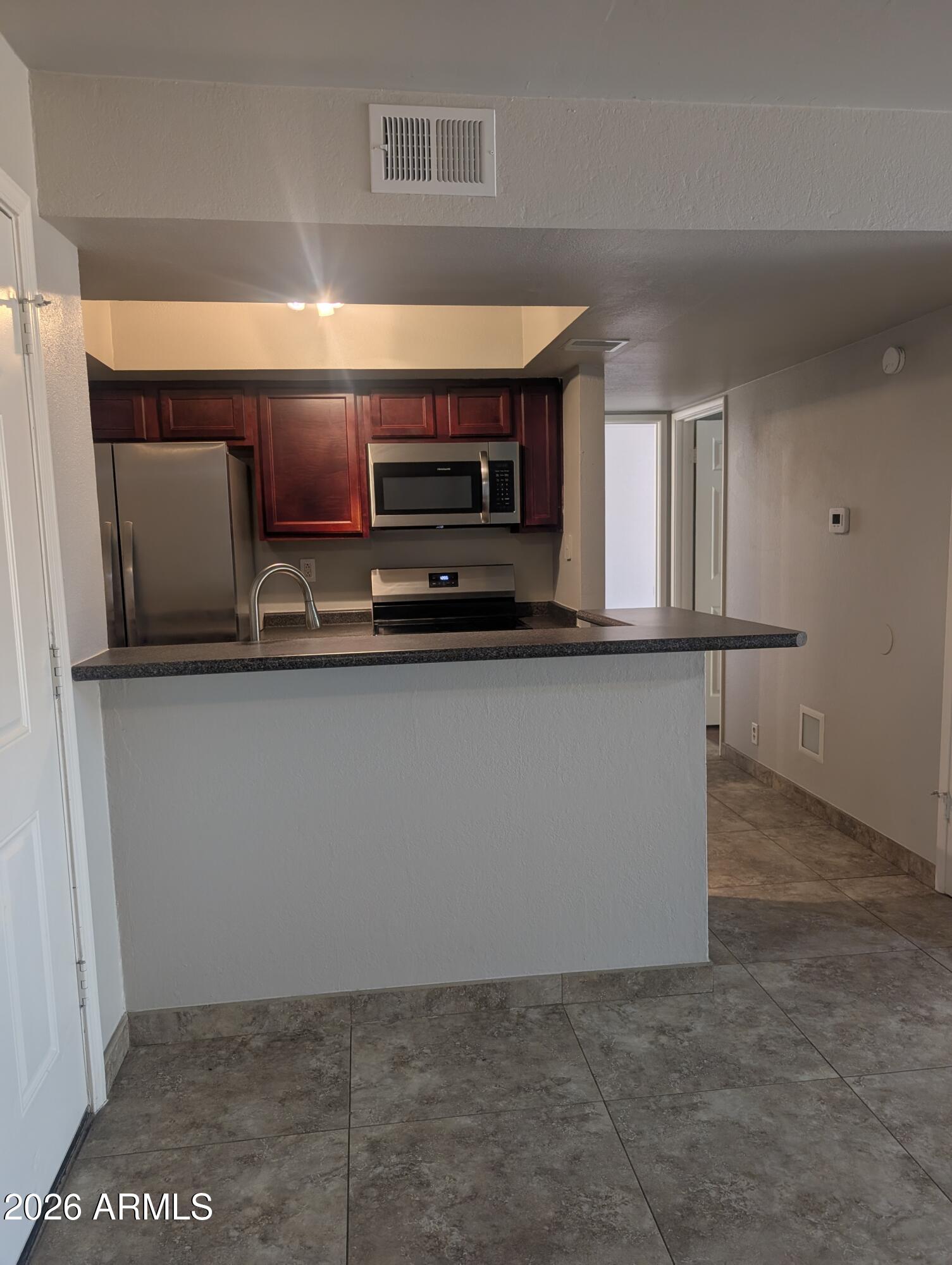540 North May, Unit 1101 Mesa, AZ 85201 - Photo 3 of 15 Room for barstools, eat in kitchen