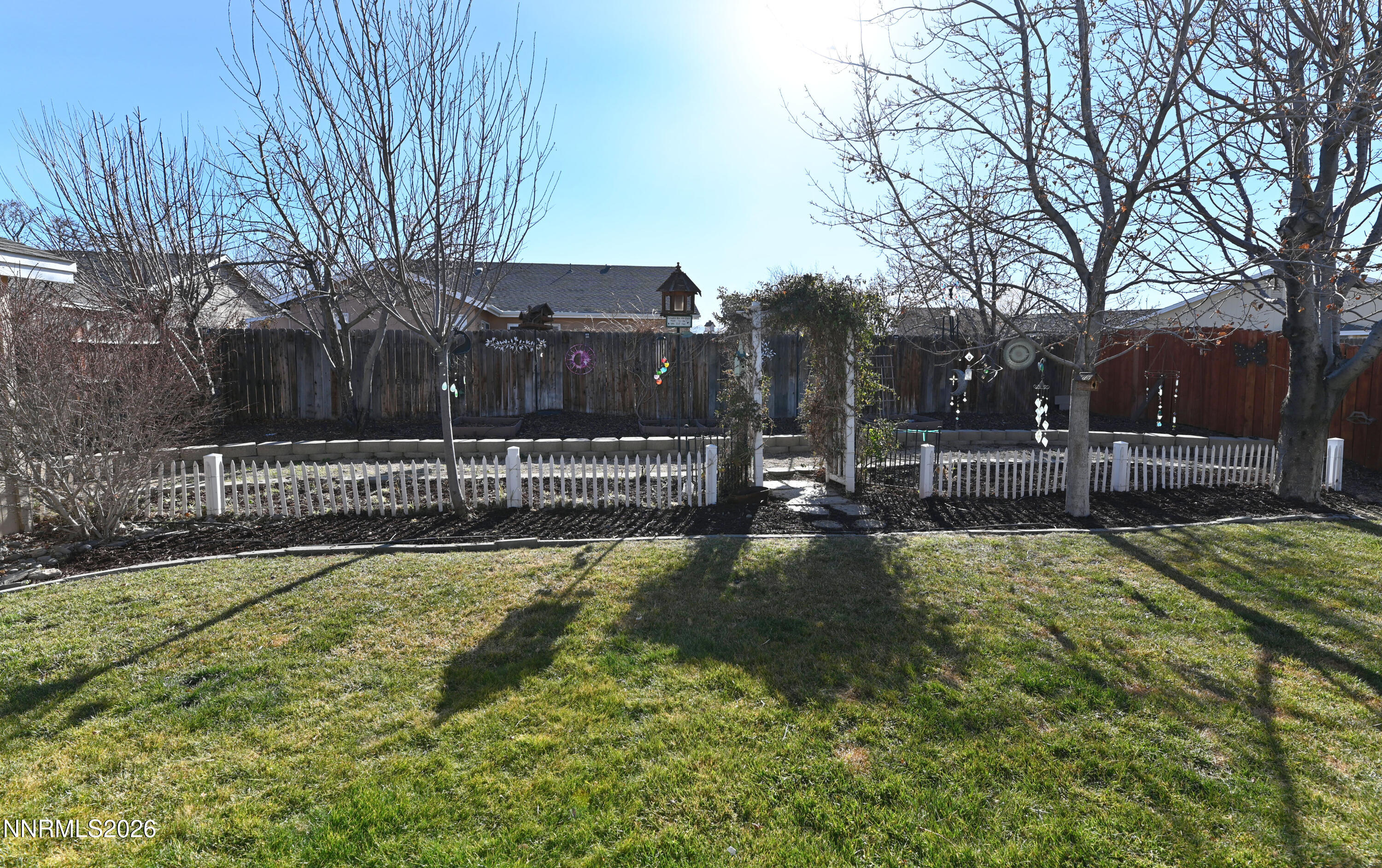 413 Sunshine Lane Fernley, NV 89408 - Photo 8 of 10 a view of swimming pool with lawn chairs and wooden fence