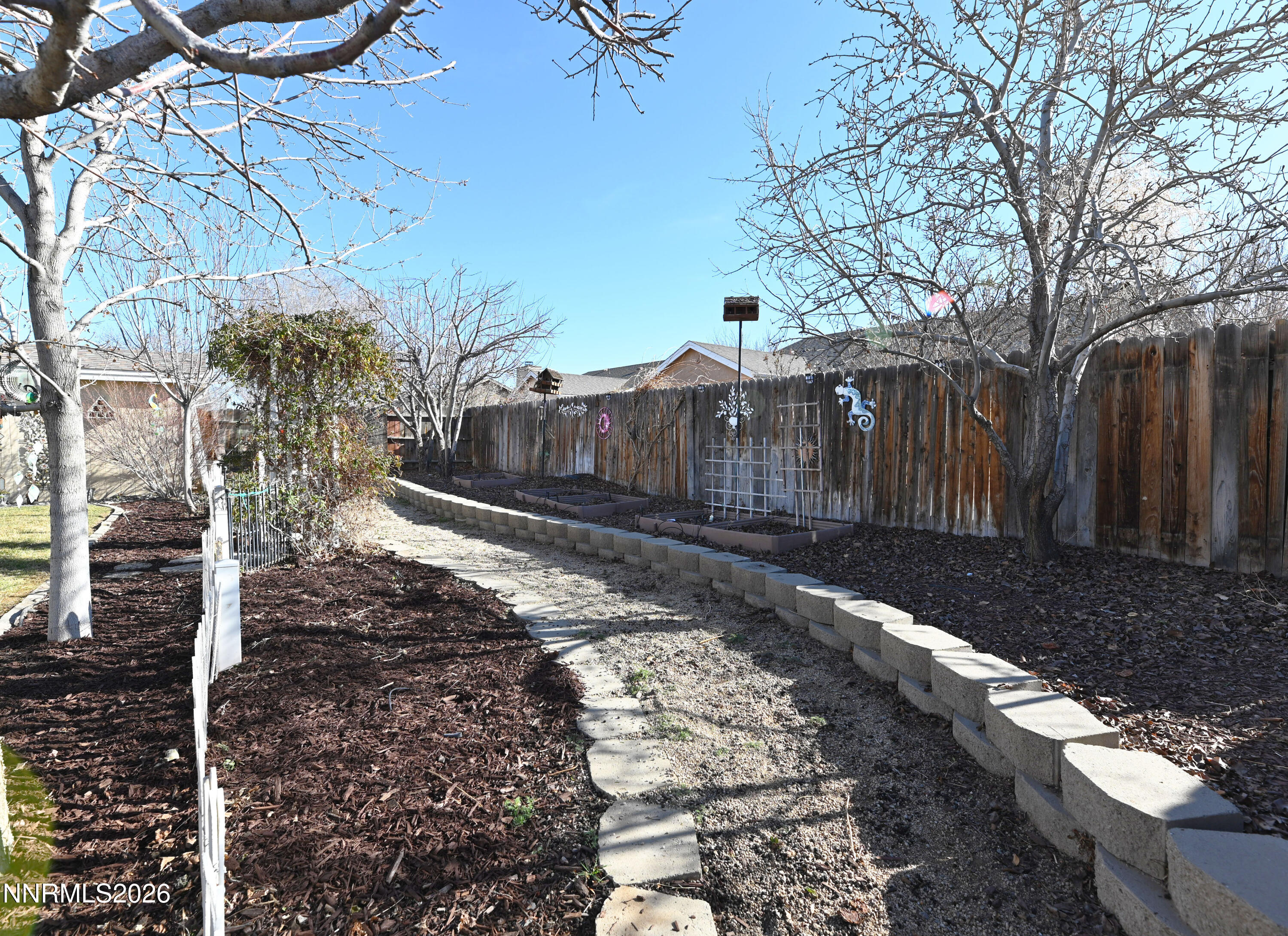 413 Sunshine Lane Fernley, NV 89408 - Photo 9 of 10 a view of a yard with wooden fence