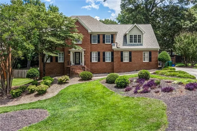 a front view of a house with garden and porch