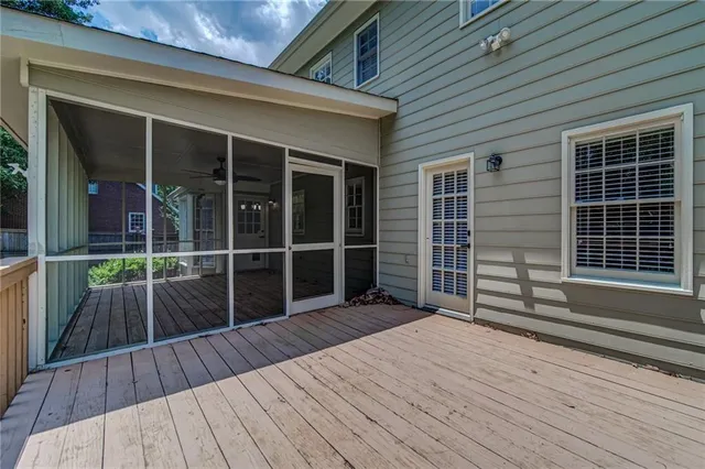 a view of deck with wooden floor and floor to ceiling window