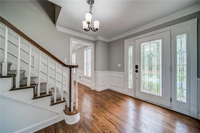 a view of entryway and hall with wooden floor