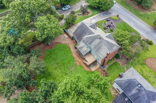 an aerial view of a house with garden space and street view