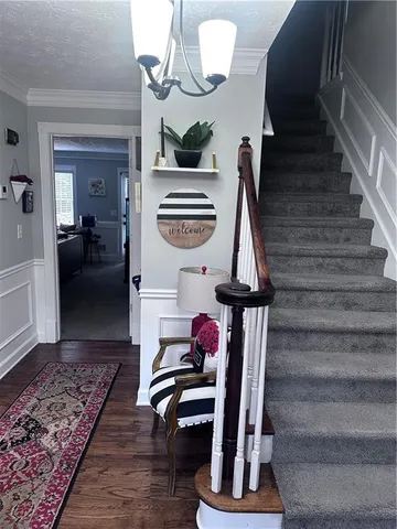 a view of entryway and hall with wooden floor