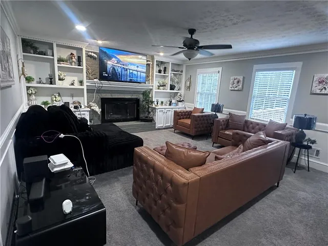 a living room with furniture and a fireplace