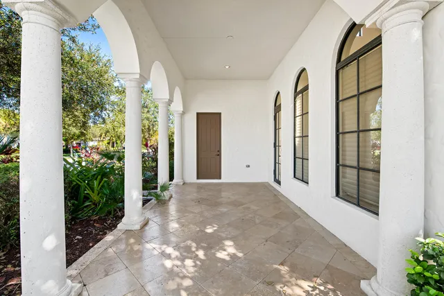 a bathroom with a granite countertop sink vanity mirror and toilet