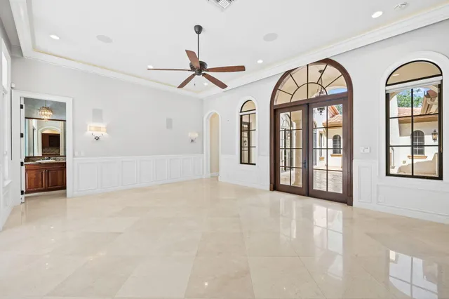 a en suite bathroom with a granite countertop double vanity sink a mirror and a bathtub