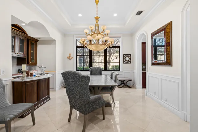 an empty room with chandelier fan and closet