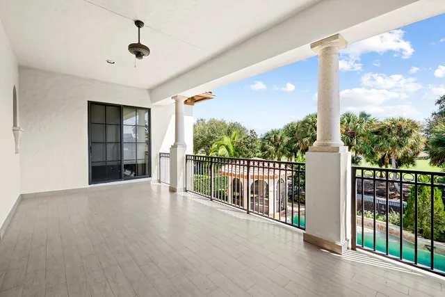 a view of staircase with lots of frames on wall and a window