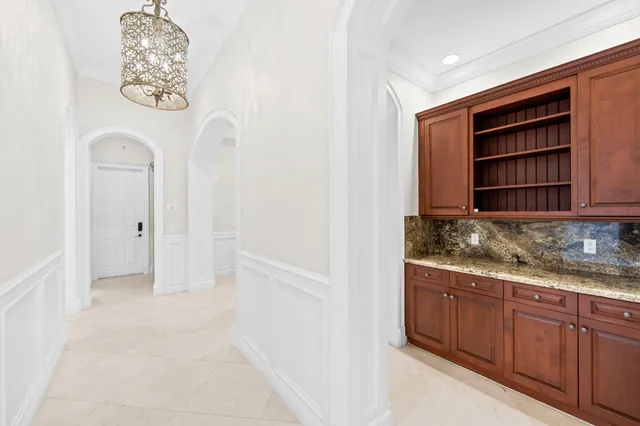 a view of a porch with furniture and floor to ceiling window