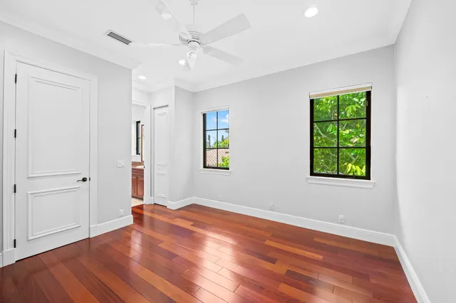 a view of a backyard with potted plants and large trees