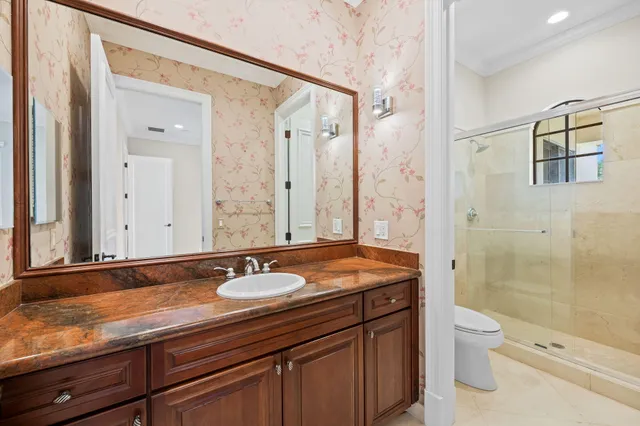 a view of a white house with a yard and potted plants