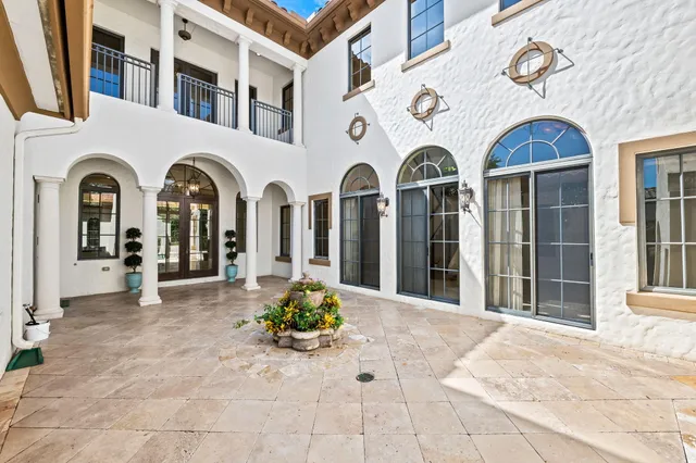 a balcony with furniture and large windows