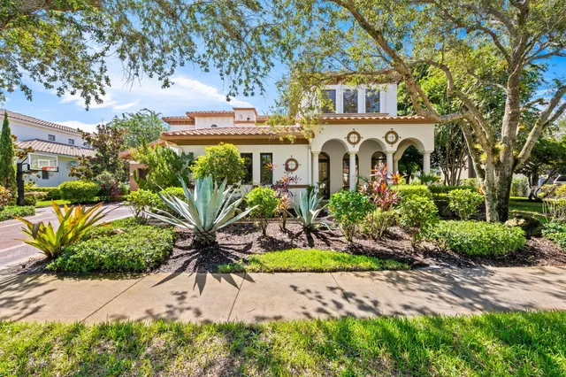 a living room with furniture two window and a ceiling fan
