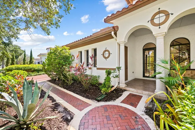 a view of a livingroom with a flat screen tv wooden floor and a ceiling fan