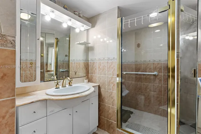 a bathroom with a shower sink and mirror