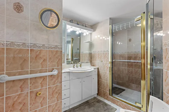 a bathroom with a shower a mirror and a sink