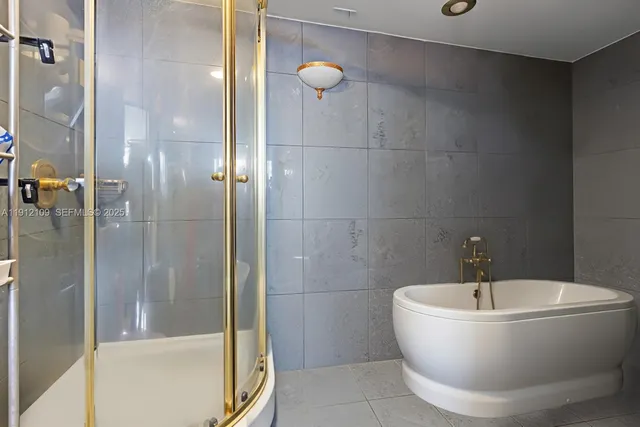 a white bath tub sitting next to a bathroom sink
