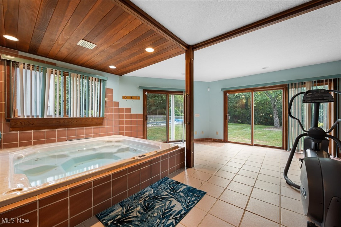 256 Everhard Road Southwest North Canton, OH 44709 - Photo 14 of 45 Full bathroom with light tile patterned floors, a garden tub, wood ceiling, and recessed lighting