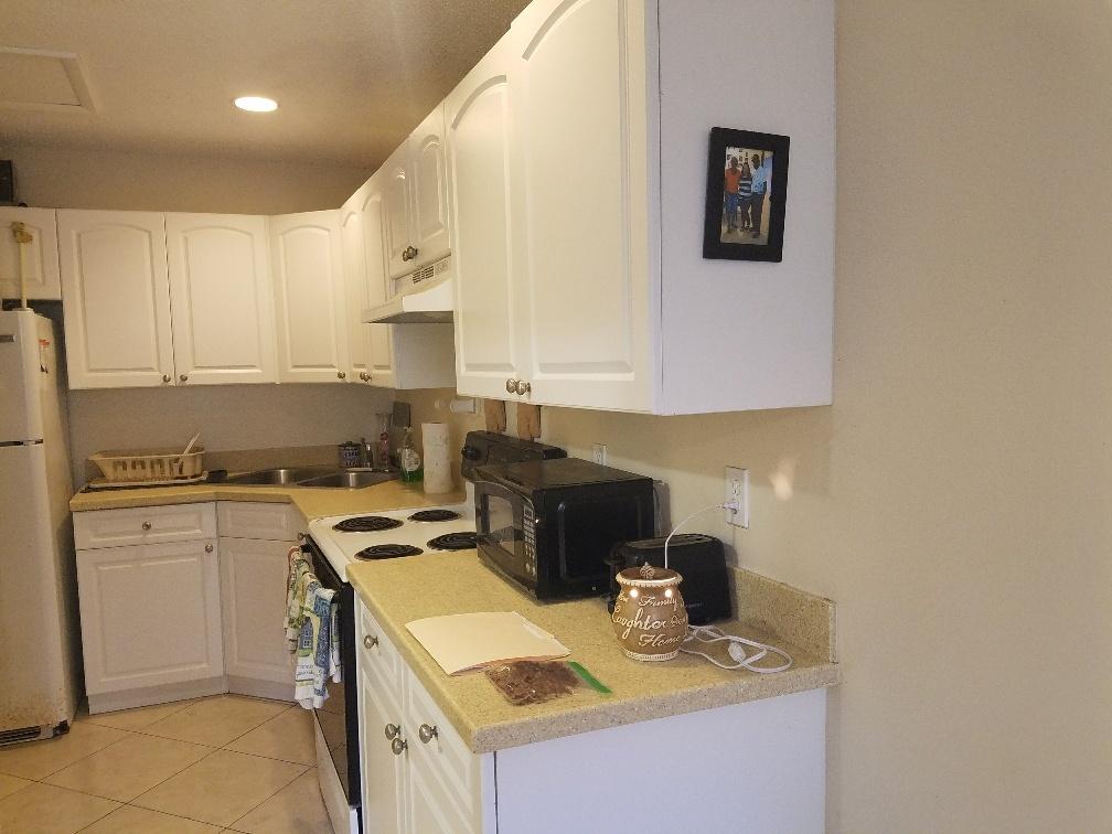 2007 Oleander Boulevard, Unit B Fort Pierce, FL 34950 - Photo 11 of 17 a kitchen with a sink a stove and cabinets