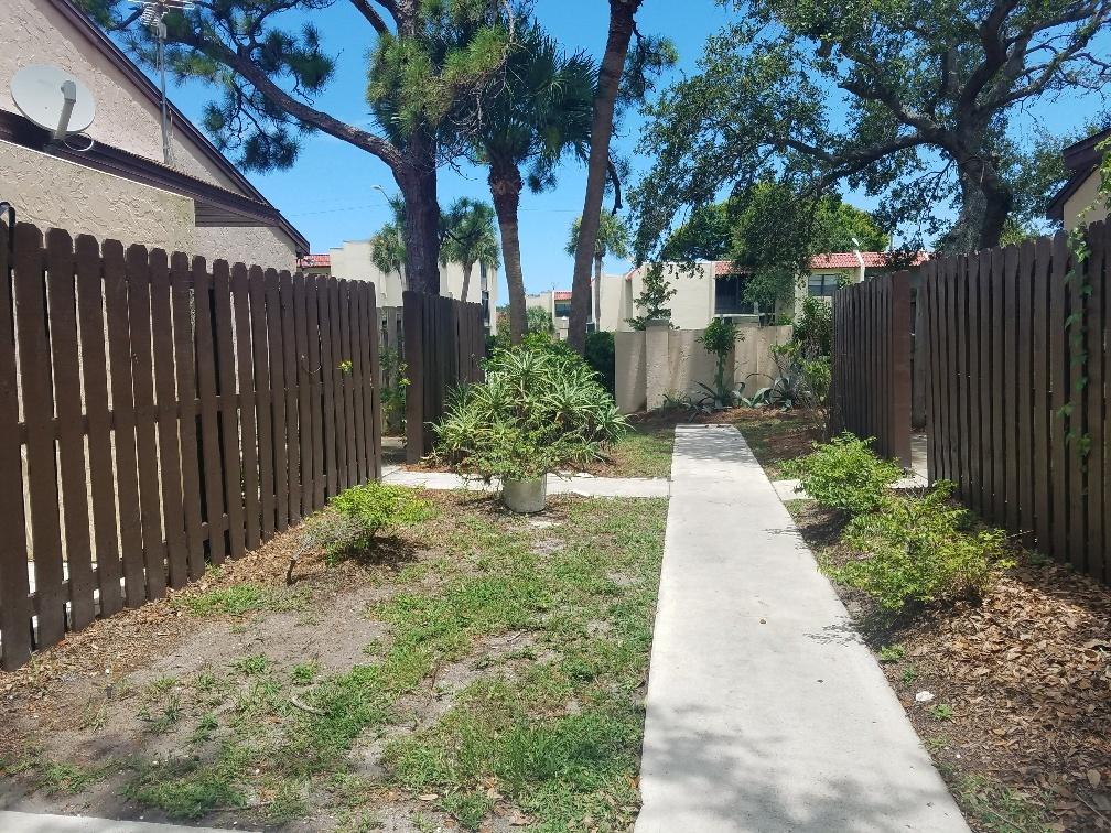 2007 Oleander Boulevard, Unit B Fort Pierce, FL 34950 - Photo 6 of 17 a view of a pathway with house on both side
