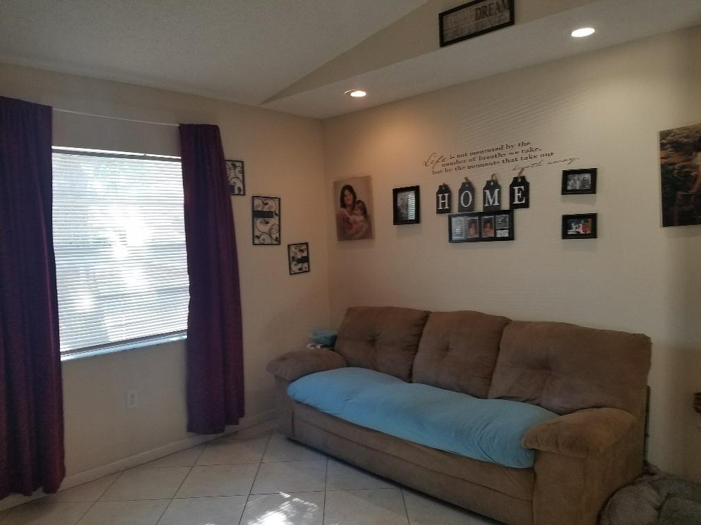2007 Oleander Boulevard, Unit B Fort Pierce, FL 34950 - Photo 8 of 17 a living room with furniture and a window