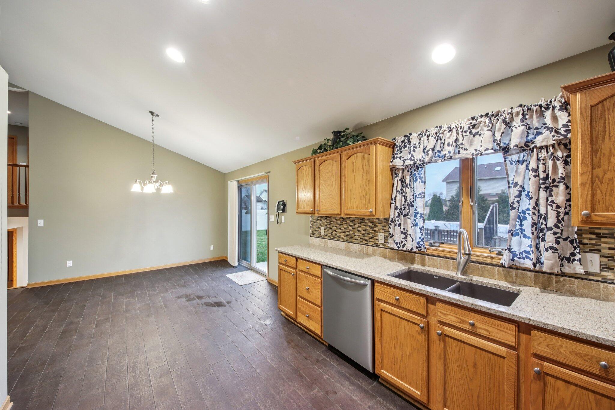 9396 Calumet Street Dyer, IN 46311 - Photo 14 of 43 a large kitchen with stainless steel appliances a sink and cabinets