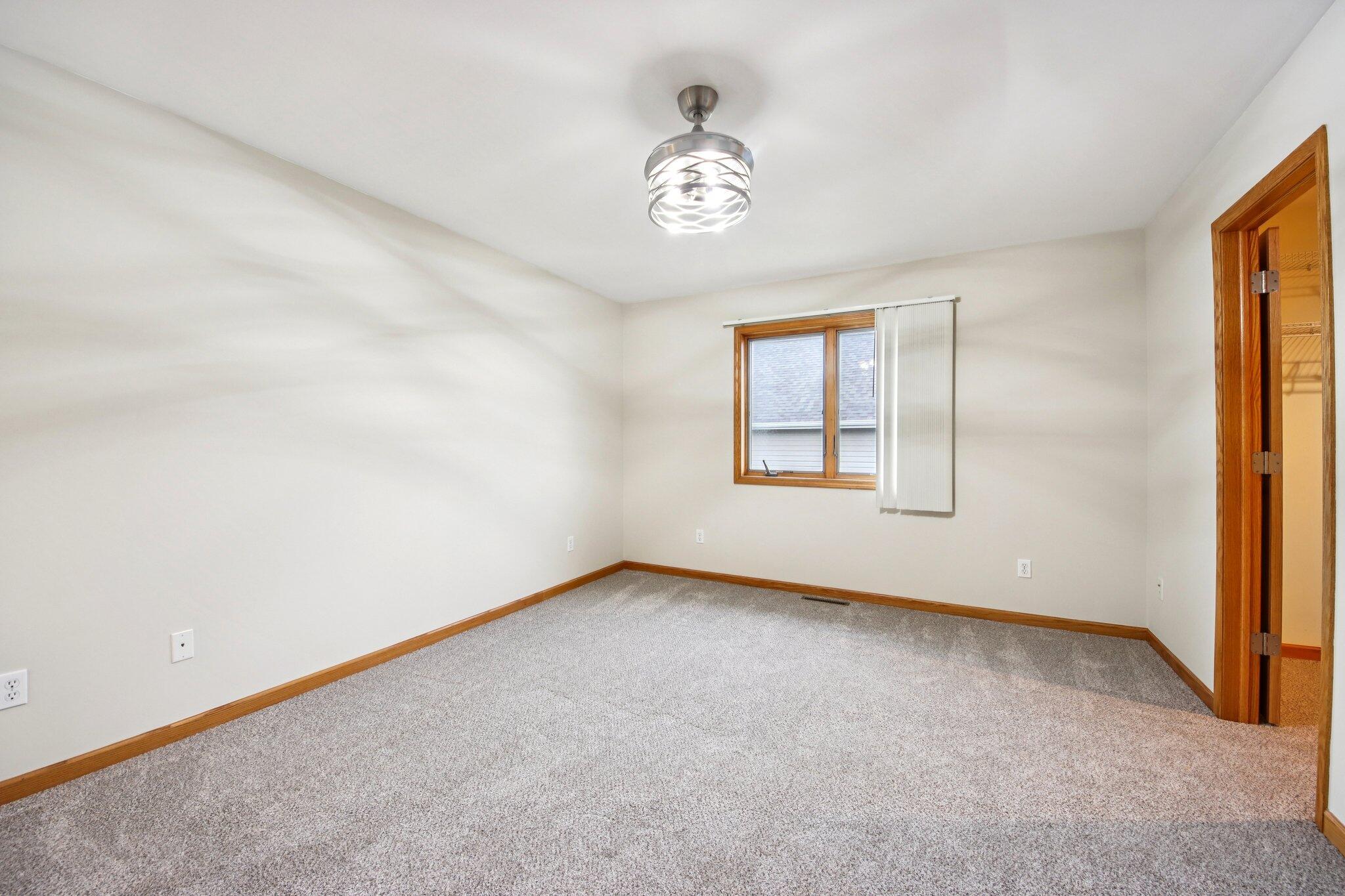 9396 Calumet Street Dyer, IN 46311 - Photo 26 of 43 an empty room with windows and chandelier fan