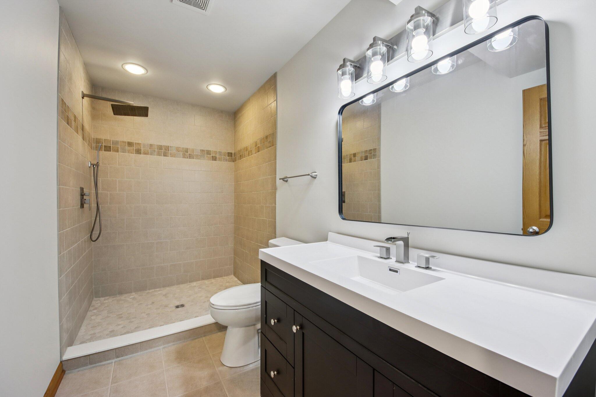 9396 Calumet Street Dyer, IN 46311 - Photo 28 of 43 a bathroom with a double vanity sink toilet and shower