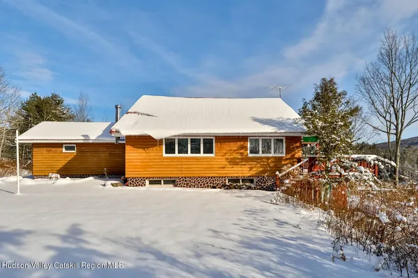 a utility room with a sink and wooden floor