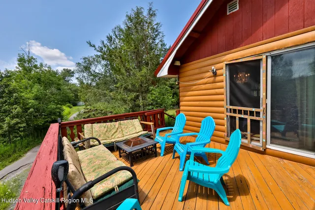 a front view of a house with outdoor seating and a patio