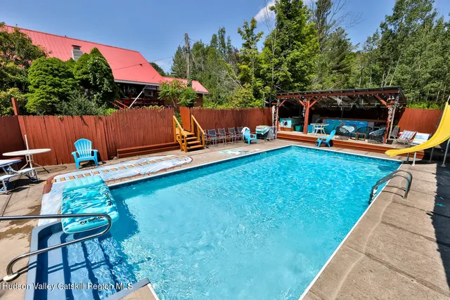 a backyard of a house with seating space and trees