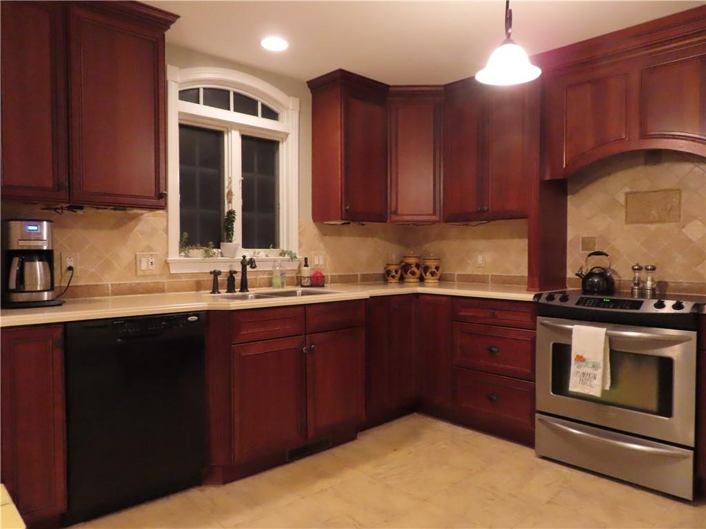194 Highway 68 Rochester, PA 15074 - Photo 4 of 33 a kitchen with stainless steel appliances granite countertop wooden cabinets a stove a sink and dishwasher