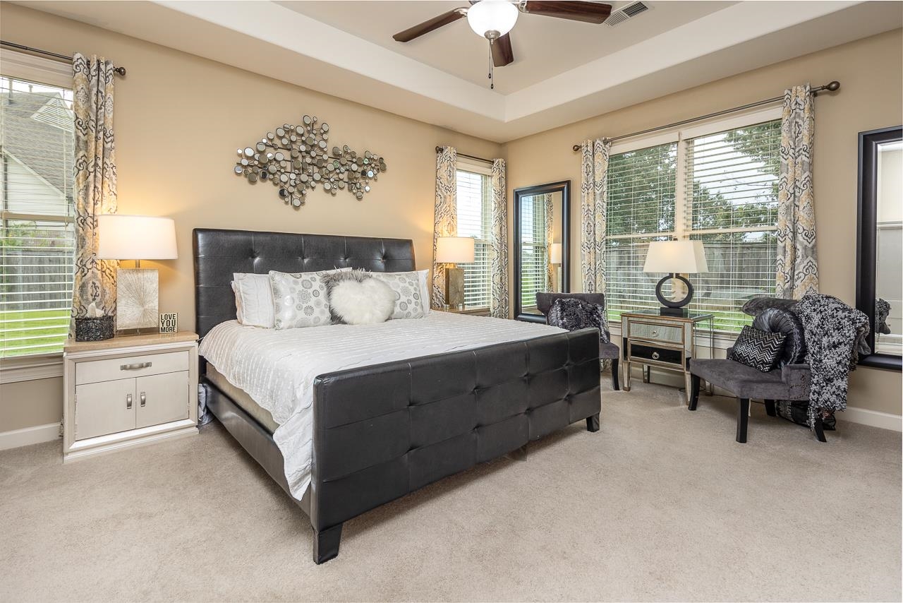 771 Six Oaks Lane Collierville, TN 38017 - Photo 13 of 25 a spacious bedroom with a bed and a couch