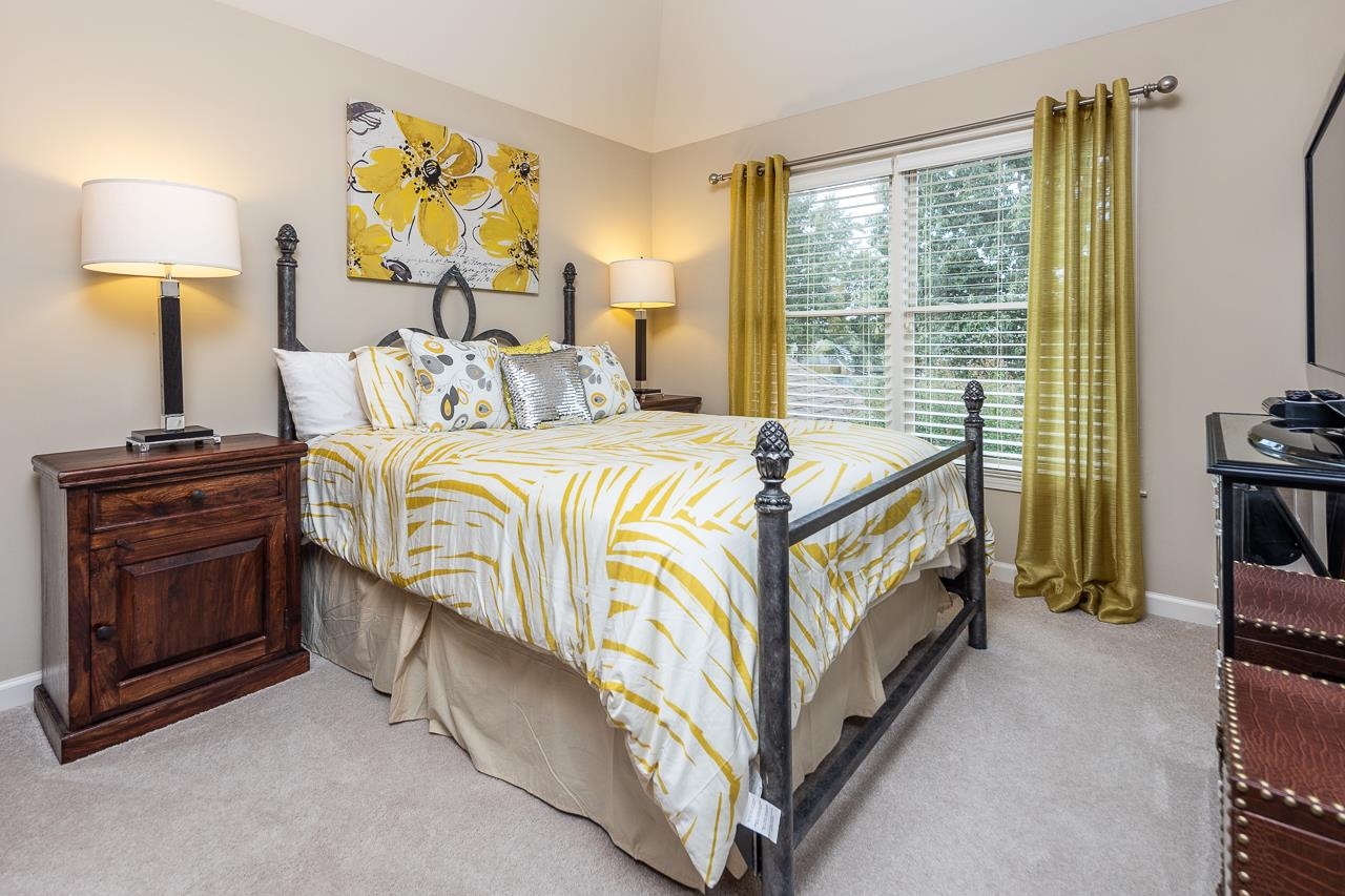771 Six Oaks Lane Collierville, TN 38017 - Photo 16 of 25 a bedroom with a bed and a lamp on table